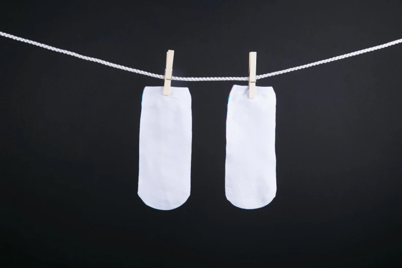 two pairs of white garment hang on a rope