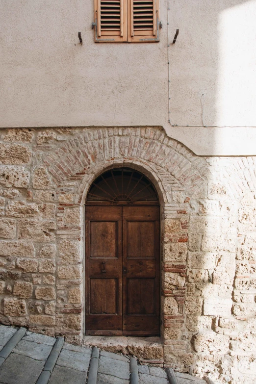 this old doorway with wood doors was built in stone