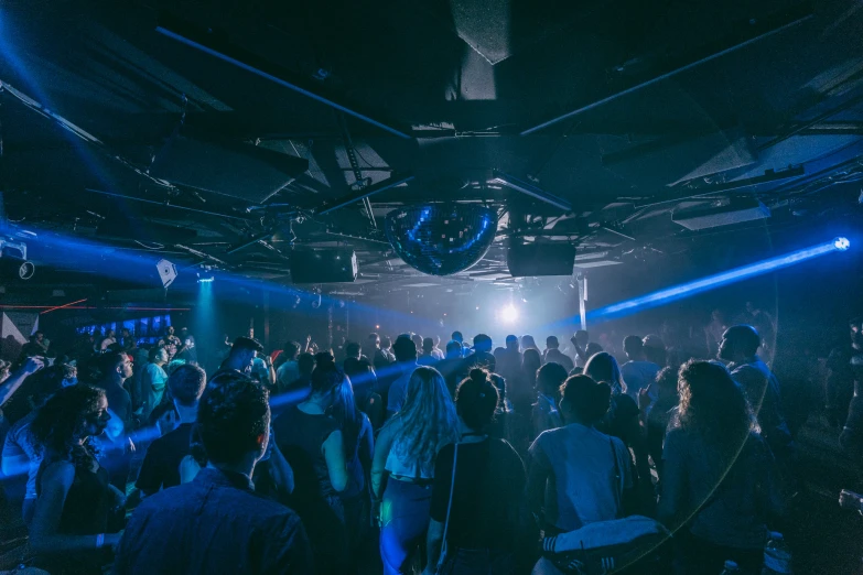 a large group of people dancing in an establishment