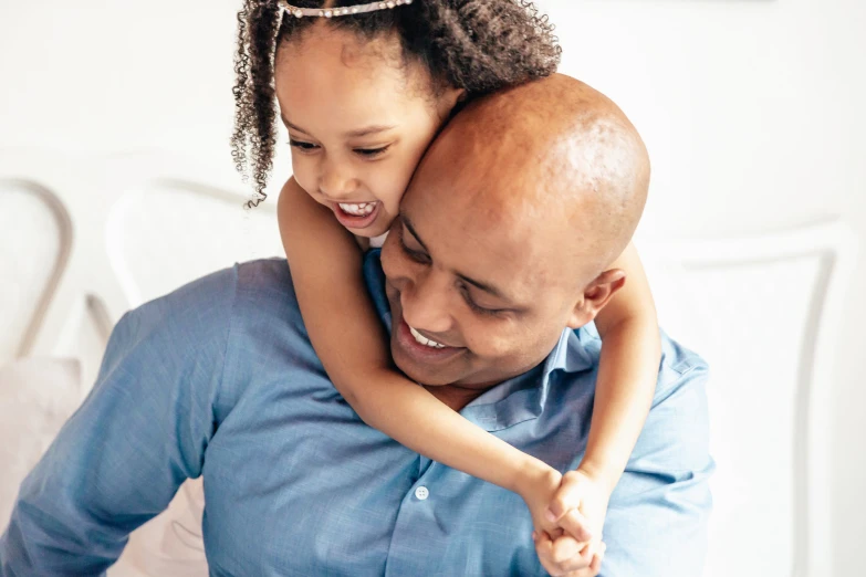 a young child piggybacking an older man