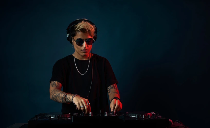 a male dj wearing headphones is playing a song