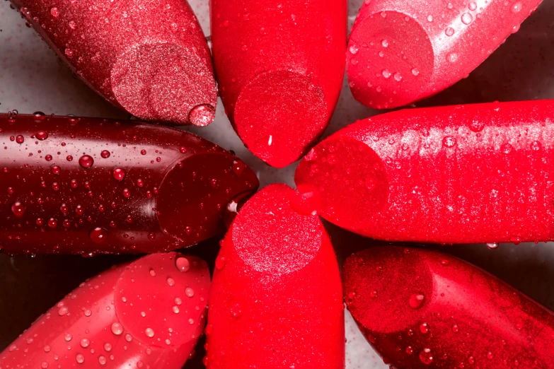 a large red lipstick on a white surface