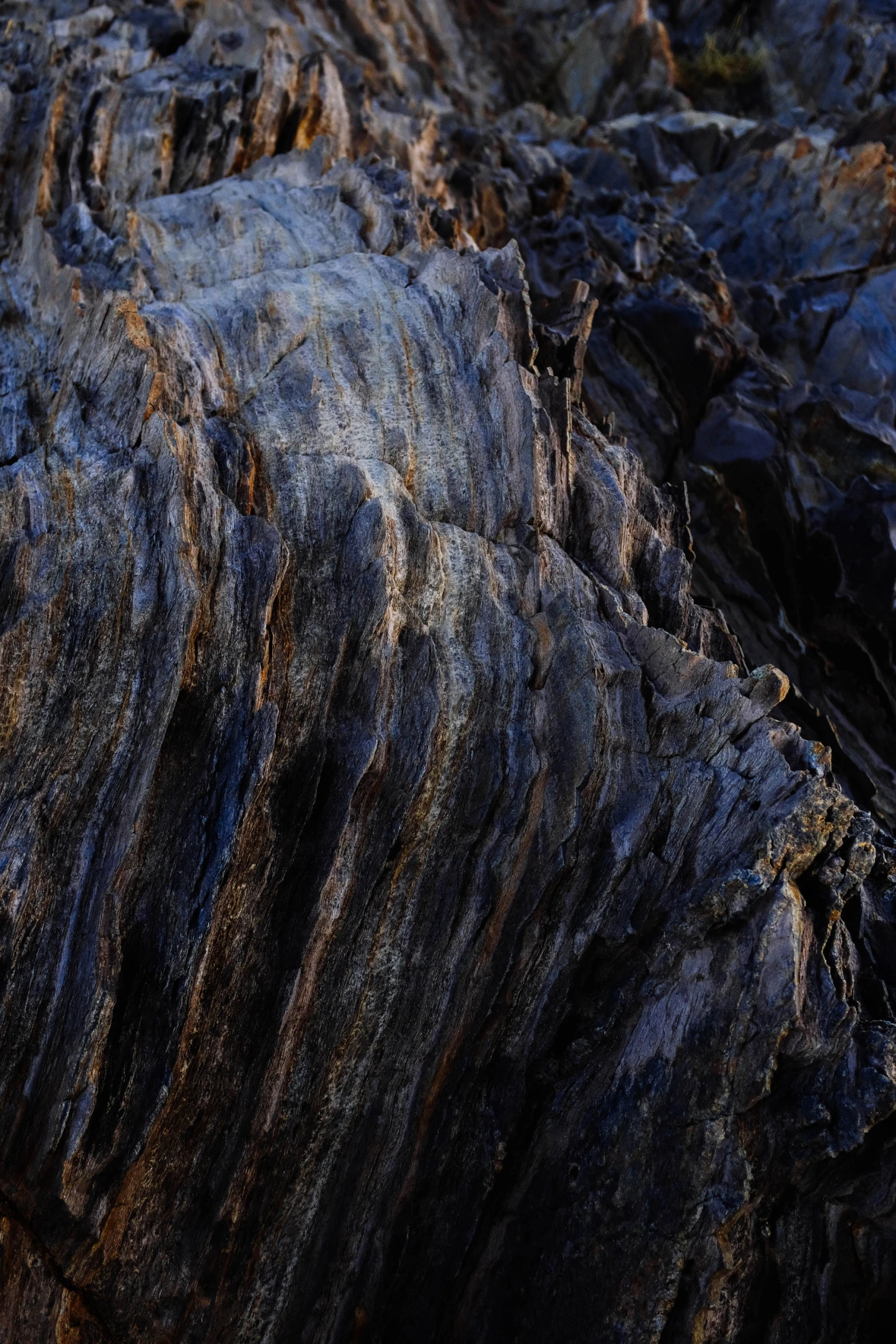 some large rocks on the ground with little patches of sun