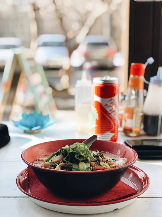 the bowl of soup is sitting on a plate