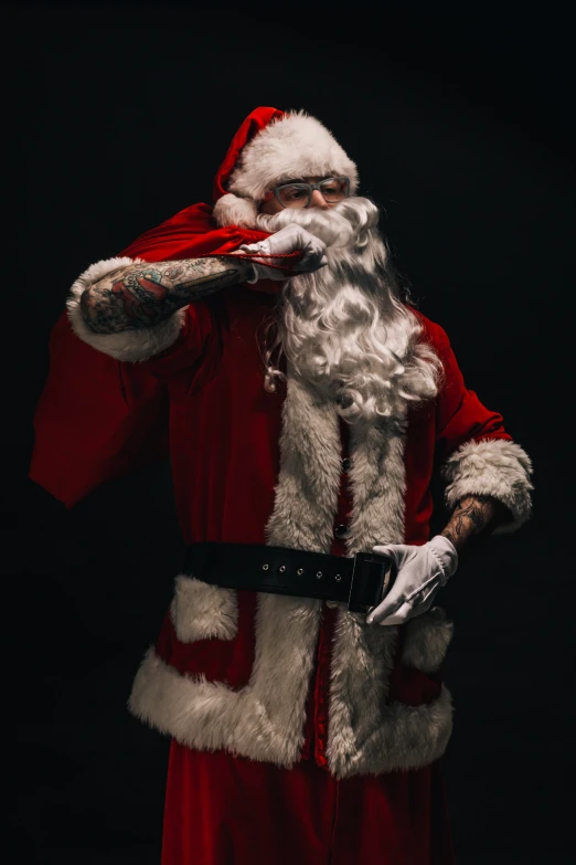 a man dressed as santa claus putting on his gloves