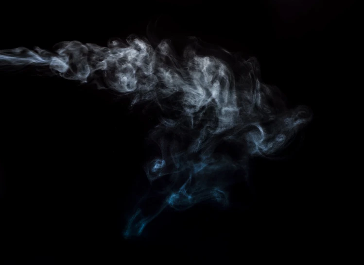 black background with smoke coming out of a cigarette