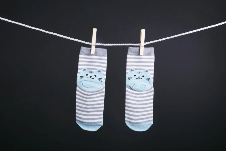 two pairs of socks that have cats printed on them