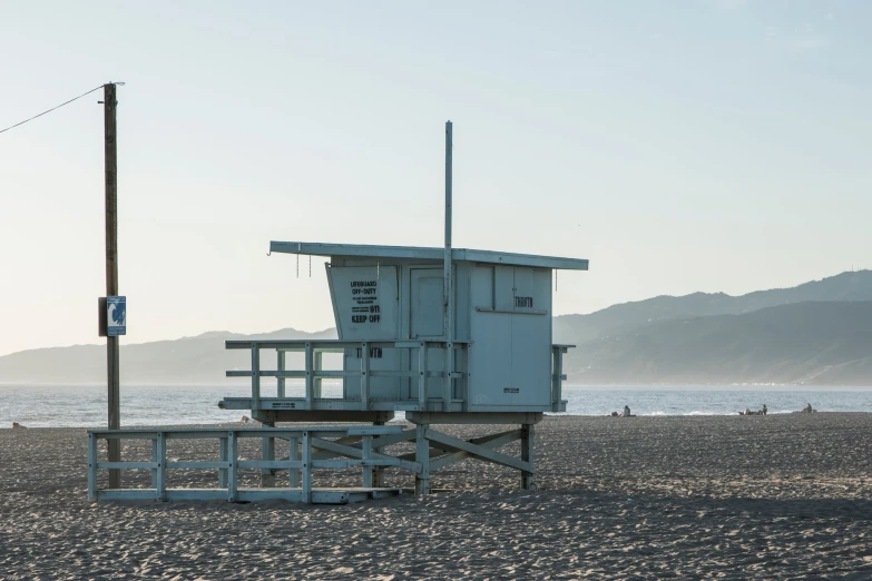 a lifeguard tower sitting in the sand on the beach