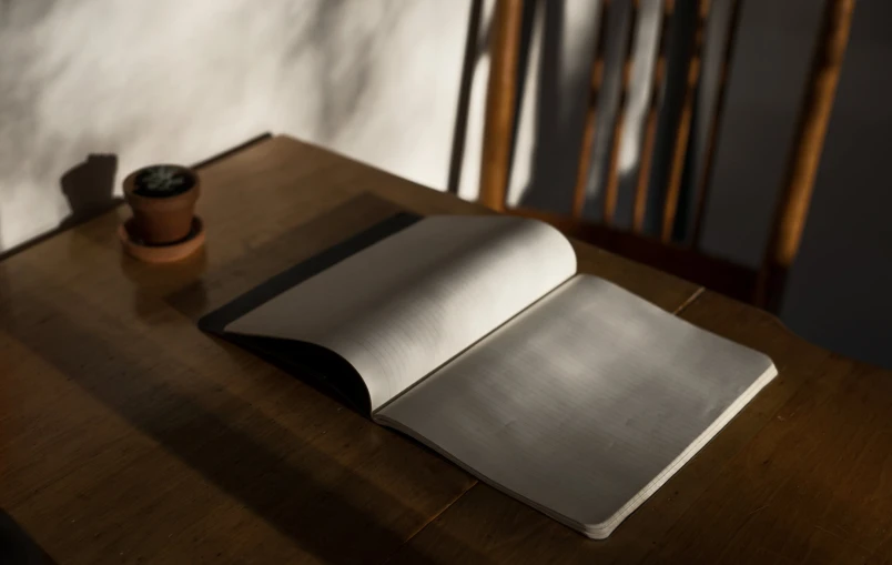 an open book sits on a wooden table