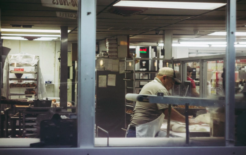 a man working at a work bench in a store