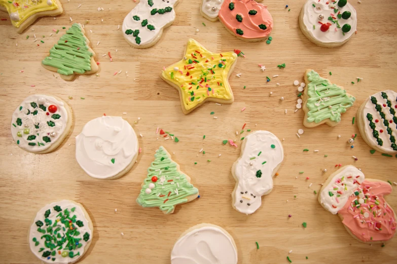 a table with many decorated cookies and small pieces