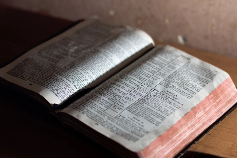 an open book on a table that is not made