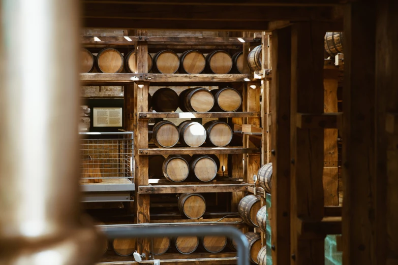 many shelves are stacked full of whisky barrels