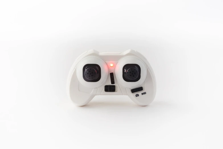 a white game controller on a white surface