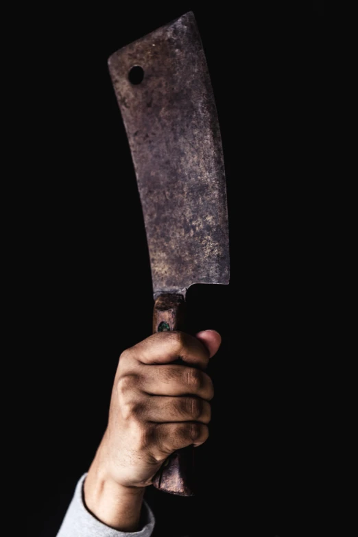 a man holding a knife up to the camera