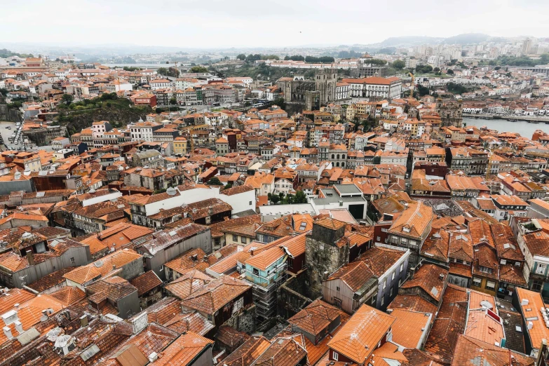 a city is covered in orange tiles and trees