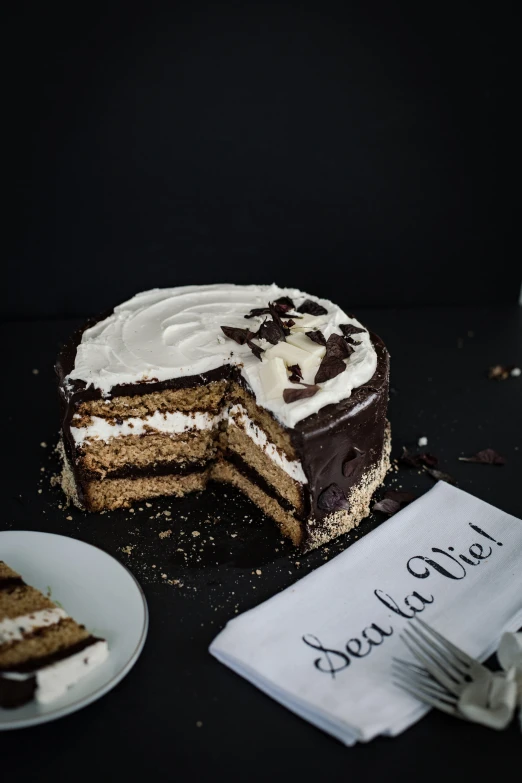 cake that is sliced with white icing and some chocolate decorations