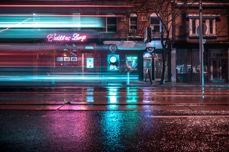 city street at night with colorful blur from cars coming by