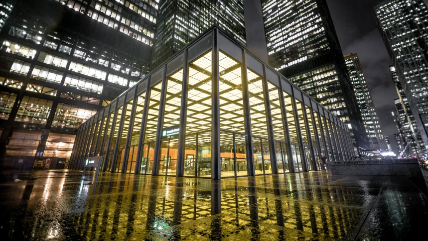 an illuminated building near a body of water