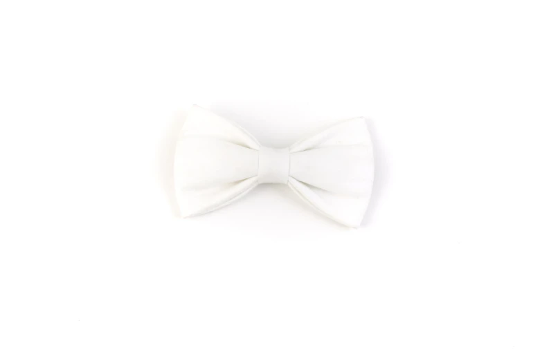 a white bow tie on a plain white surface