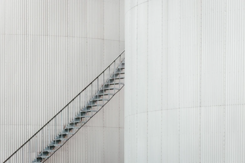 a staircase near a wall with a white paneled wall