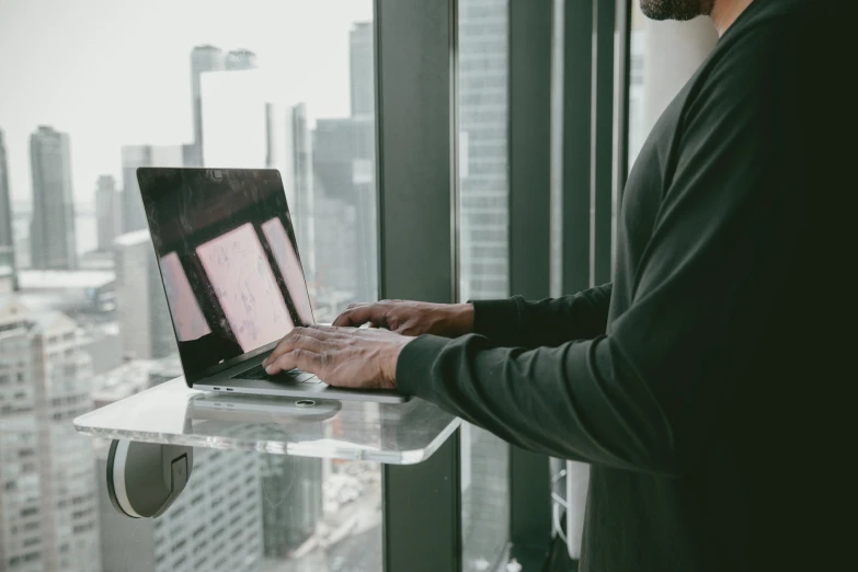 a man is looking at a computer that's open