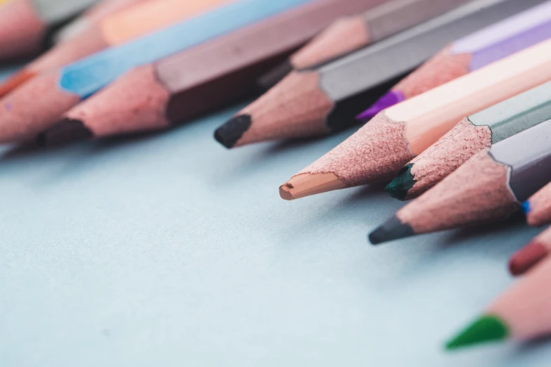 many colored pencils lined up close together