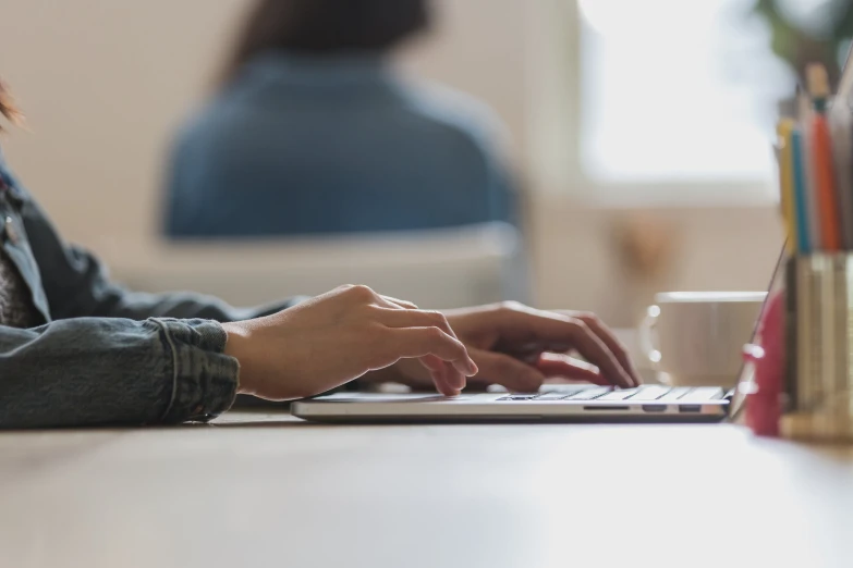 a woman on a laptop on a desk