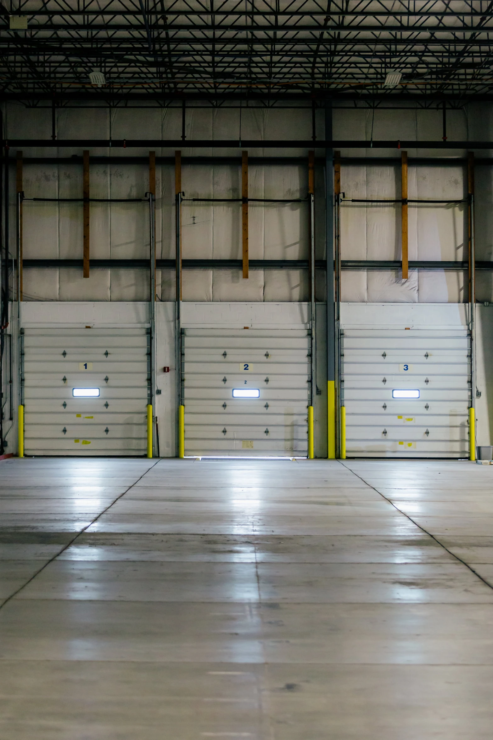 a garage with multiple empty metal doors in it