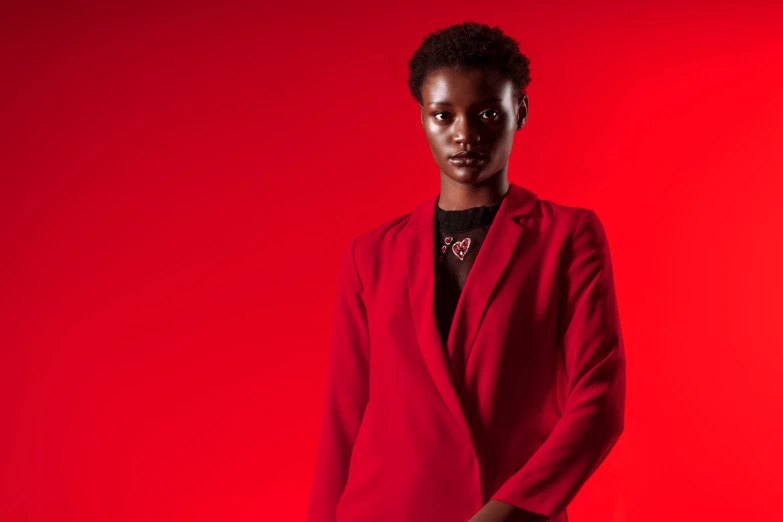 a woman is dressed in red and is posing for a po