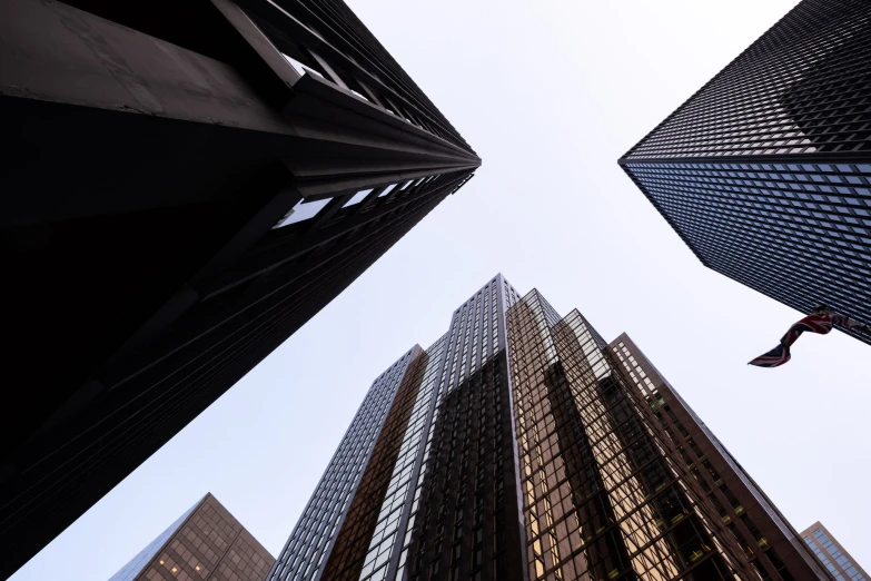 tall buildings with a sky scr hanging from them