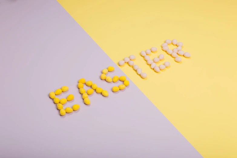 a white and yellow background with many small pills