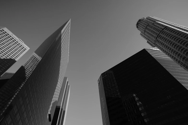 two skyscrs are seen in the middle of black and white