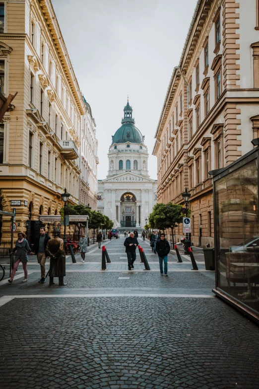 a city street with people walking around and old buildings