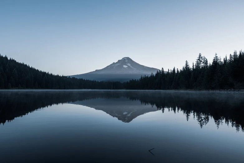 an image of the reflection of a mountain in the water