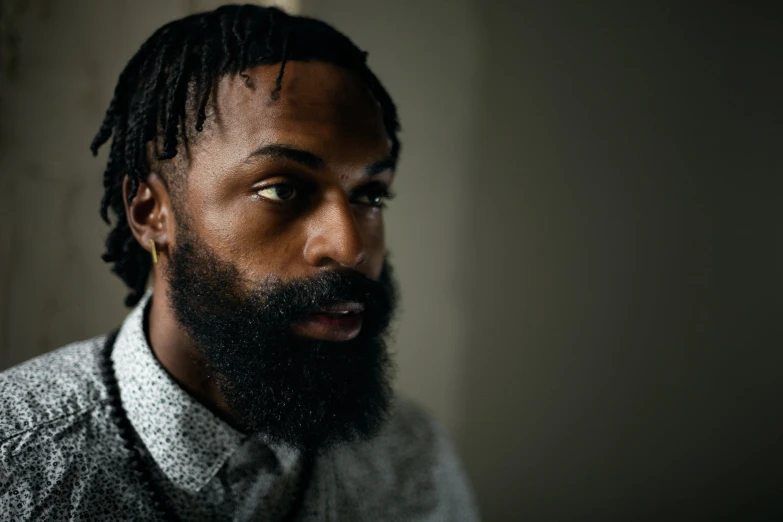 a close up of a person with dreads