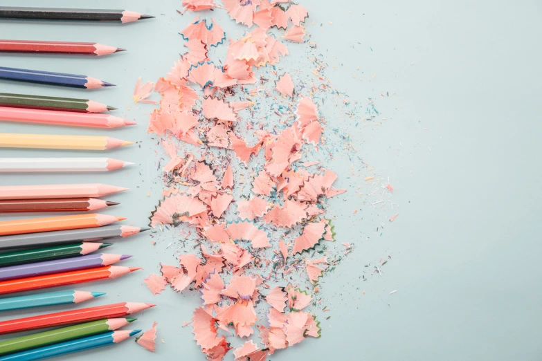 some pastel and crayons are spilled with colored pencils