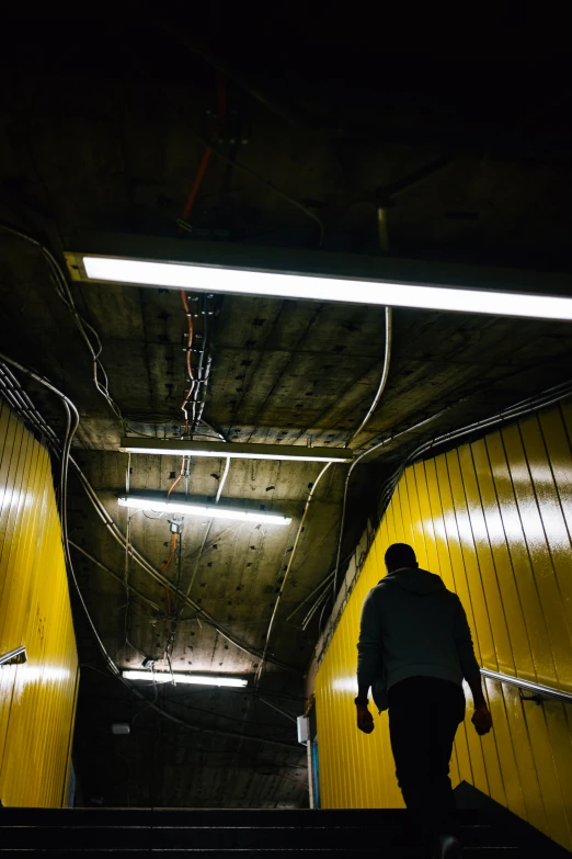 a person is standing on a stairwell at night