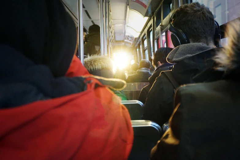 people on a subway with some lights shining