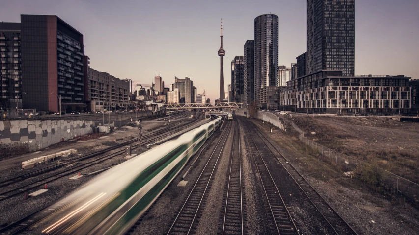 a railroad track with lots of buildings in the background