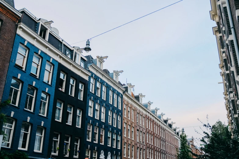 a blue building along side other buildings that look like a row of houses