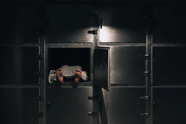 a person laying down in a metal room