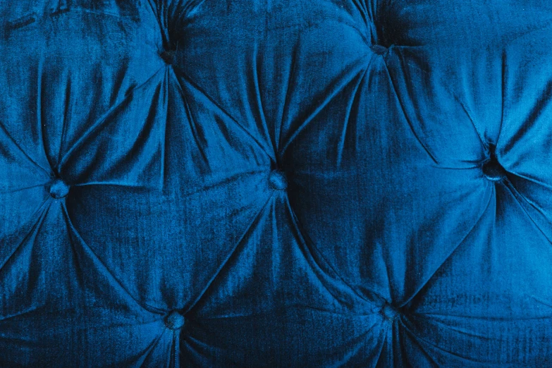 the back of an upholstered chair, with blue paint