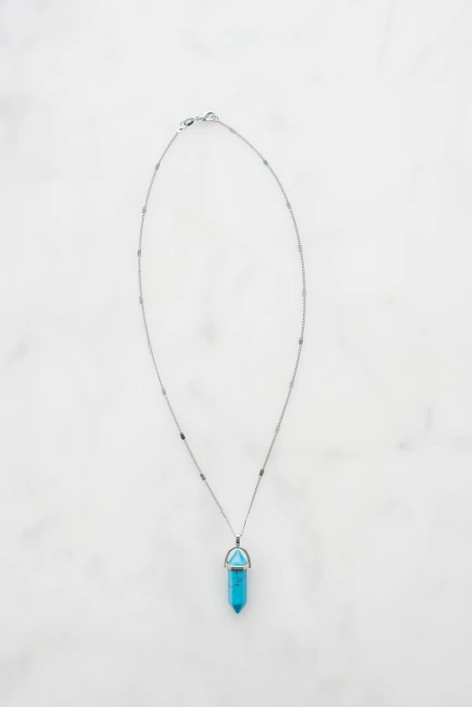 a necklace with a chain and stone drop