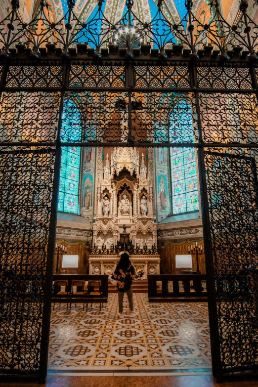 a person standing in a large area with columns and windows