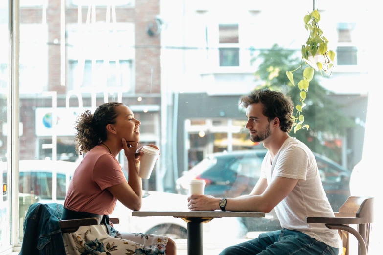 a man and a woman talking at the table