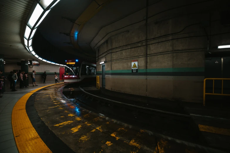 people are walking in front of the large passenger train