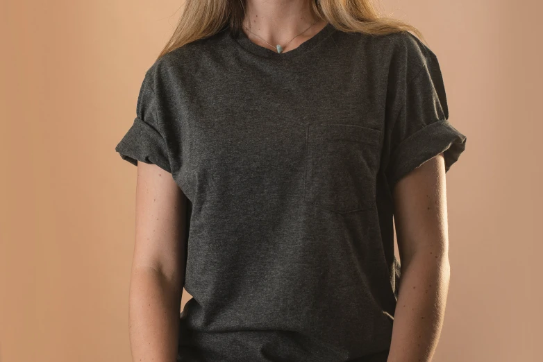 a woman posing in front of a tan background