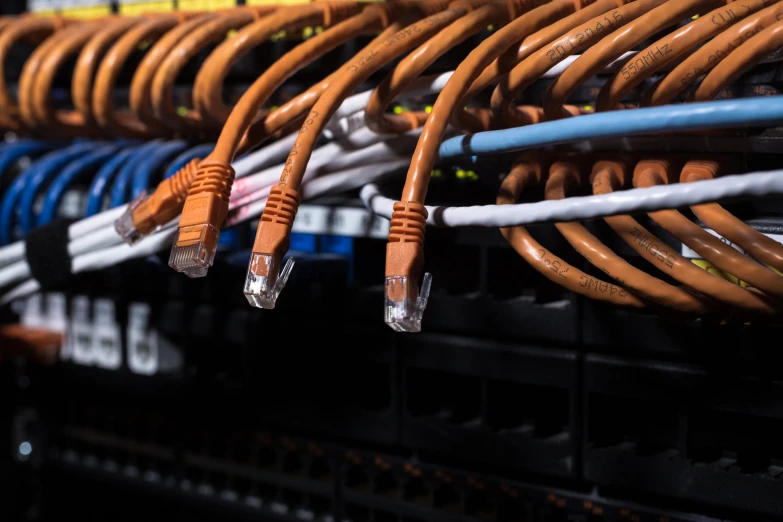 a group of copper colored electrical cords are stacked together