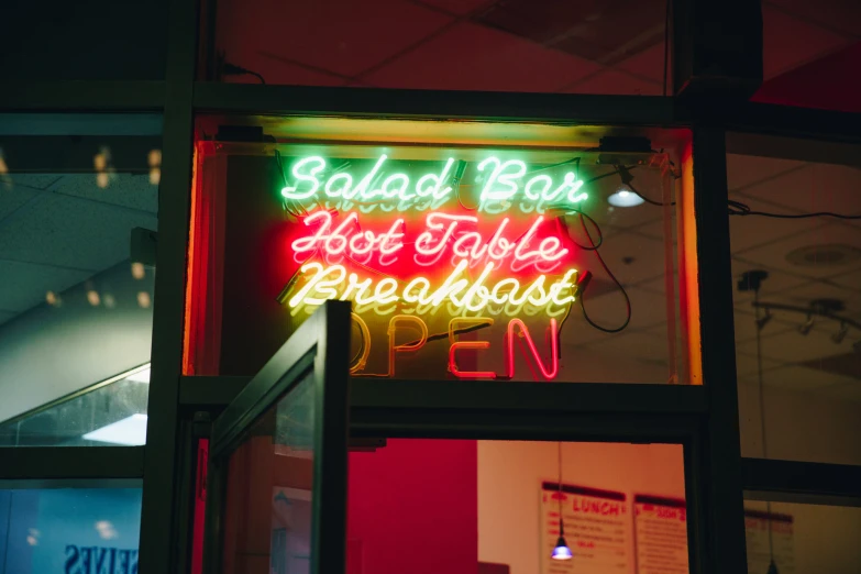 a neon sign advertising the restaurant